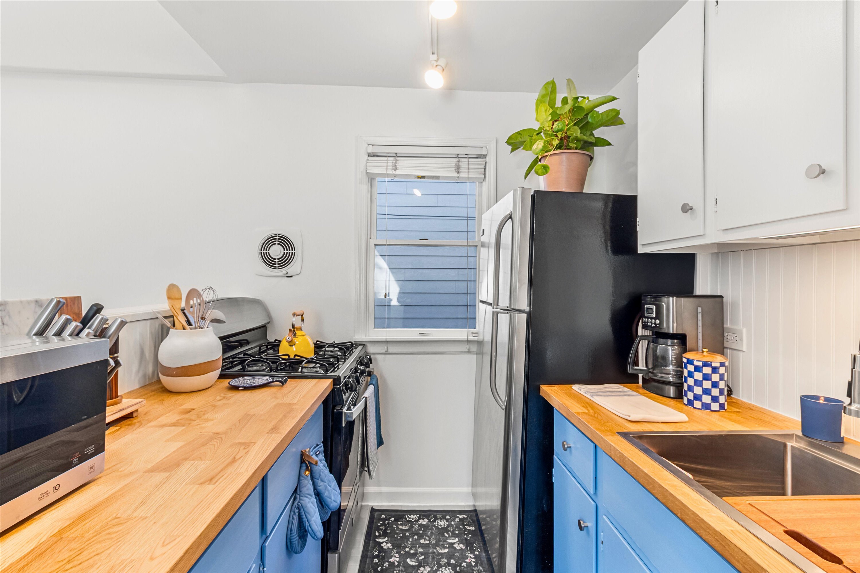 Full kitchen with blue cabinets
